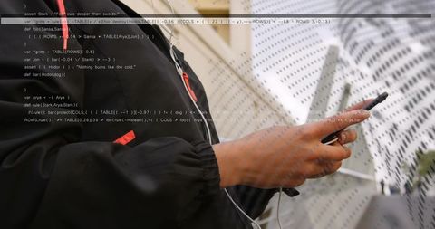 Hands holding phone under white umbrella tapping screen in rainy city with code overlay