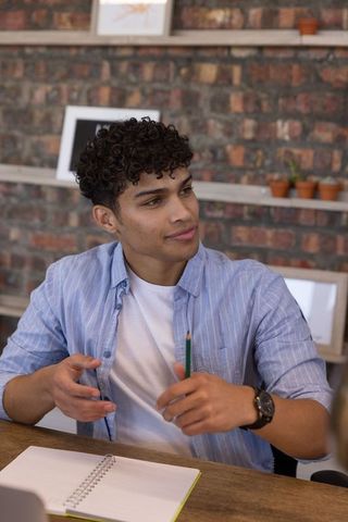 Male Student Engaging in Productive Study Session in Cozy Home Office