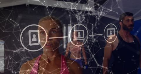 Female athlete using augmented reality fitness tracking in group gym training session