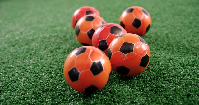 Red and Black Patterned Soccer Balls on Green Artificial Turf - Download Free Stock Images Pikwizard.com