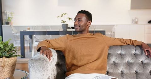 Man Relaxing on Stylish Sofa in Modern Living Room