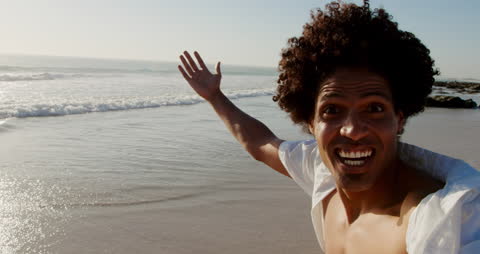 Joyful Man Taking Selfie on Sunny Beach Shoreline