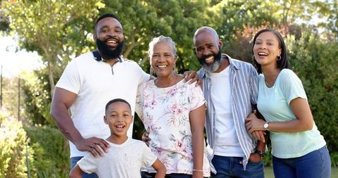 Smiling Three-Generation African Family in Garden Setting