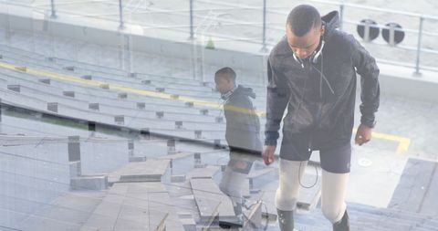 Athlete with Prosthetic Legs Training in Stadium