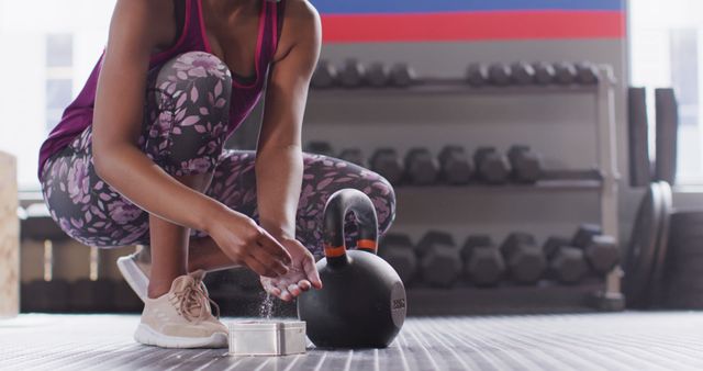 Image of low section of african american woman powdering hands before lifting kettlebell at gym - Download Free Stock Photos Pikwizard.com