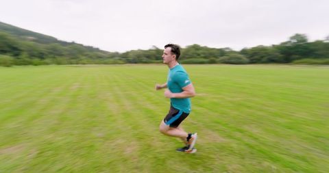 Man jogging in lush green field for outdoor fitness