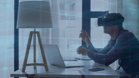 Man Engaging with Virtual Reality Technology at Work Desk