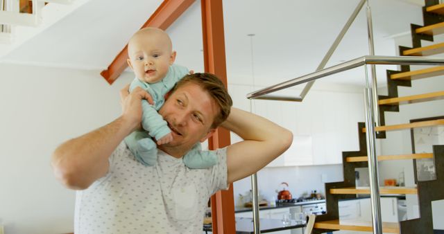 Father Carrying Baby on Shoulders in Modern Home Interior - Download Free Stock Images Pikwizard.com