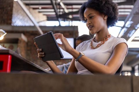 Businesswoman Using Tablet in Modern Open-Plan Office