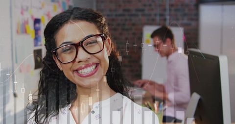 Happy businesswoman with financial graph overlay in modern office