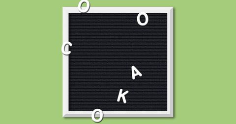 Scattered letters on black felt board school concept