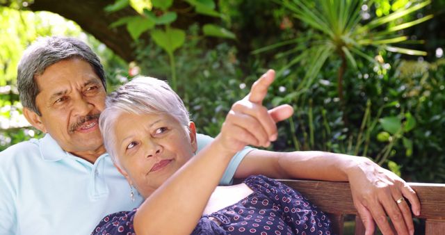 An elderly Asian couple shares a content moment outdoors, indicating a close bond. - Download Free Stock Photos Pikwizard.com