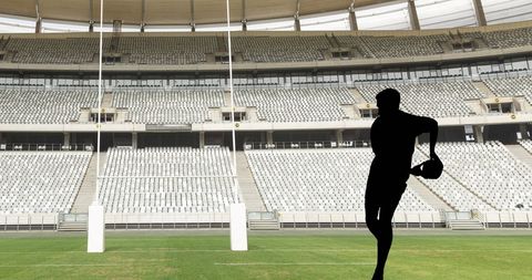 Rugby Player Silhouette in Massive Empty Stadium Scene