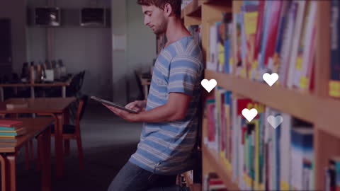 Young Man Using Digital Tablet in Library