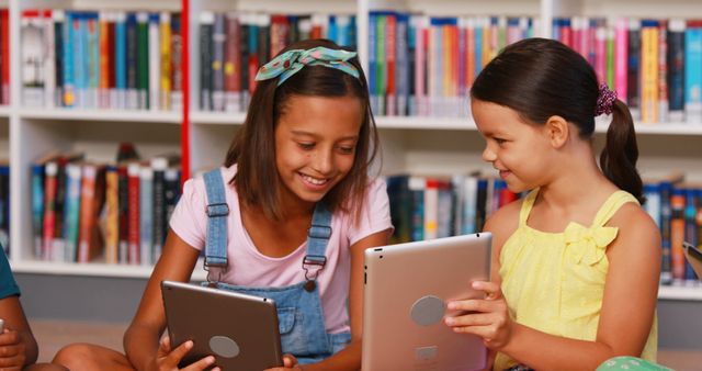 Schoolchildren Engaging with Digital Tablets in Library - Download Free Stock Images Pikwizard.com