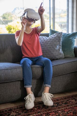Young Woman Enjoying Virtual Reality in Modern Living Room
