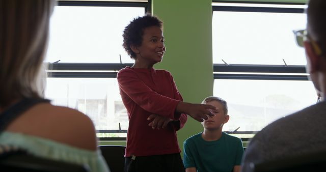 Confident Young Boy Speaking in Group Classroom Setting - Download Free Stock Images Pikwizard.com