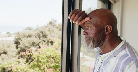 Mature Man Contemplating Peacefully by Window