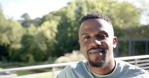 Portrait of Man Relaxing Outdoors in Sunny Park Setting