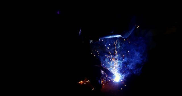 Welder at Work with Sparks in Dark Workshop - Download Free Stock Images Pikwizard.com