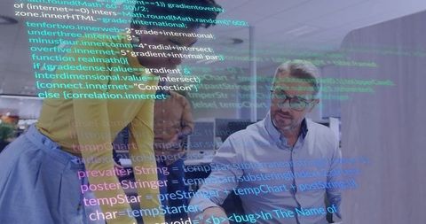 Engineers collaborating on live code review through glass partition with digital overlay