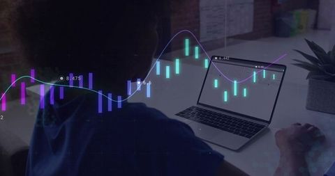 Analyst Monitoring Stock Charts on Laptop in Modern Workspace