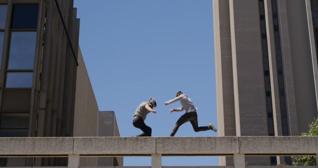 Urban Parkour Jump Between Buildings Against Blue Sky - Download Free Stock Images Pikwizard.com
