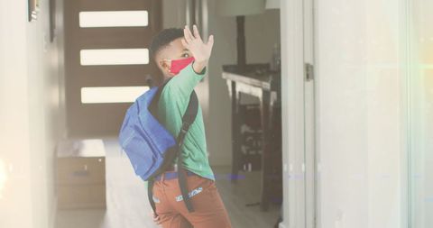 Boy Wearing Mask Waving While Going to School