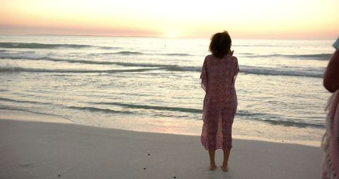 Serene Sunset on Sandy Beach with Gently Lapping Waves