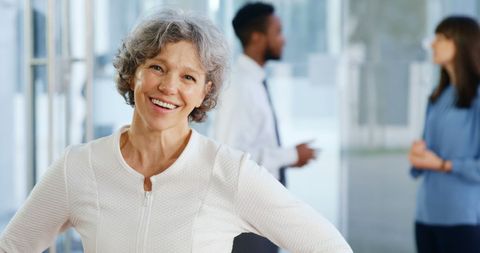 Confident Mature Businesswoman Smiling in Modern Office