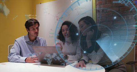 Young Professionals Collaborating with Digital Technology in Modern Office