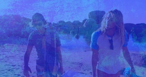 Surfers Enjoying Sunny Day at Rocky Shoreline