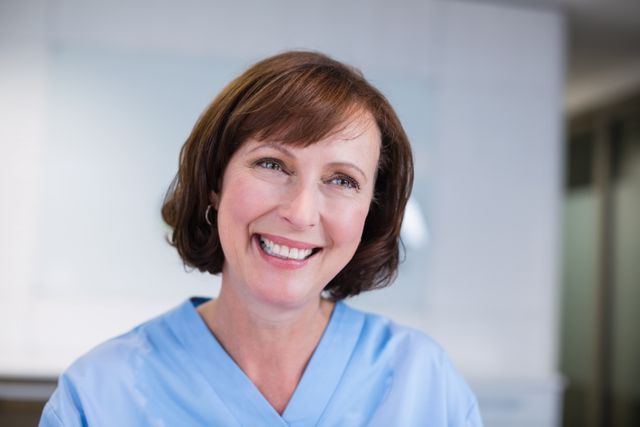Smiling nurse sitting at desk in hospital