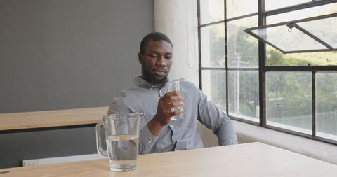 Businessman Relaxing in Office While Hydrating