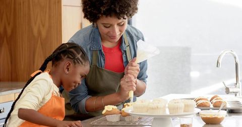 Mother and Daughter Enjoy Wholesome Baking Together in Kitchen