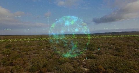 Futuristic holographic sphere over remote scrubland landscape