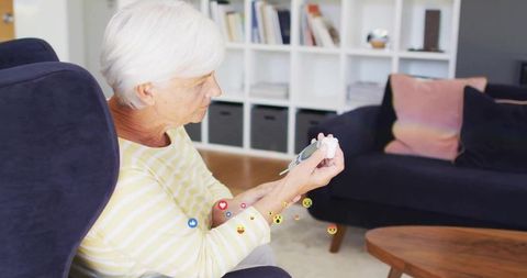 Senior woman monitoring blood sugar with glucose meter in cozy home