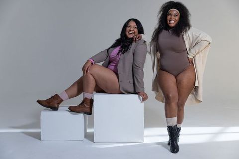 Confident plus-size diverse women modeling neutral bodysuits, boots and blazers