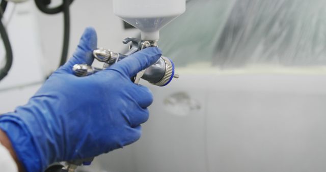 Close-Up of Worker Painting Car with Spray Gun in Auto Body Shop - Download Free Stock Images Pikwizard.com