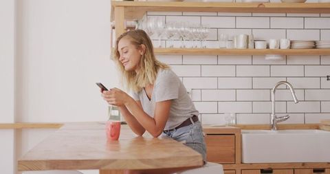 Woman Enjoying Leisure Time in Modern Kitchen