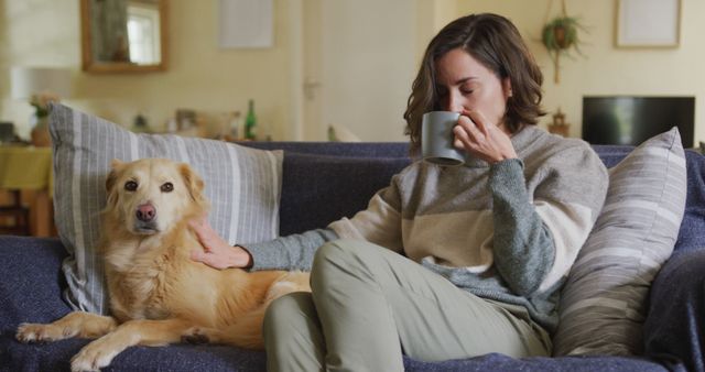 Relaxed Woman Drinking Coffee While Petting Dog on Couch - Download Free Stock Photos Pikwizard.com