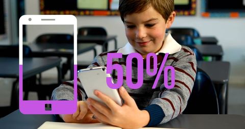 Schoolboy Engaging with Smartphone in Classroom Setting Technology