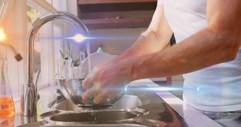 Man Washing Fresh Vegetables in Sunlit Kitchen Modern Interior