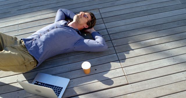 Man Relaxing on Deck with Laptop and Coffee - Download Free Stock Images Pikwizard.com