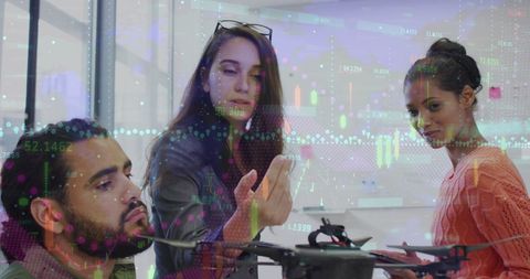 Multicultural team analyzing digital financial data in office