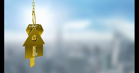 Golden keys with house keychain floating on blurred urban background