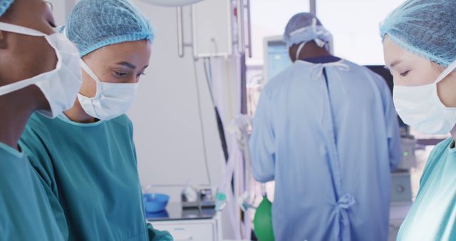 Image of three diverse female surgeons talking during operation in theatre, copy space - Download Free Stock Photos Pikwizard.com