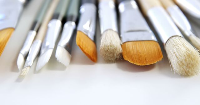 Close-Up of Assorted Paint Brushes in Various Sizes on White Surface - Download Free Stock Images Pikwizard.com