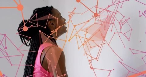 Laughing woman with braided hair tilting head amid colorful digital network overlay