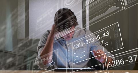 Man Concentrating on Data Analytics with Tablet in Modern Office